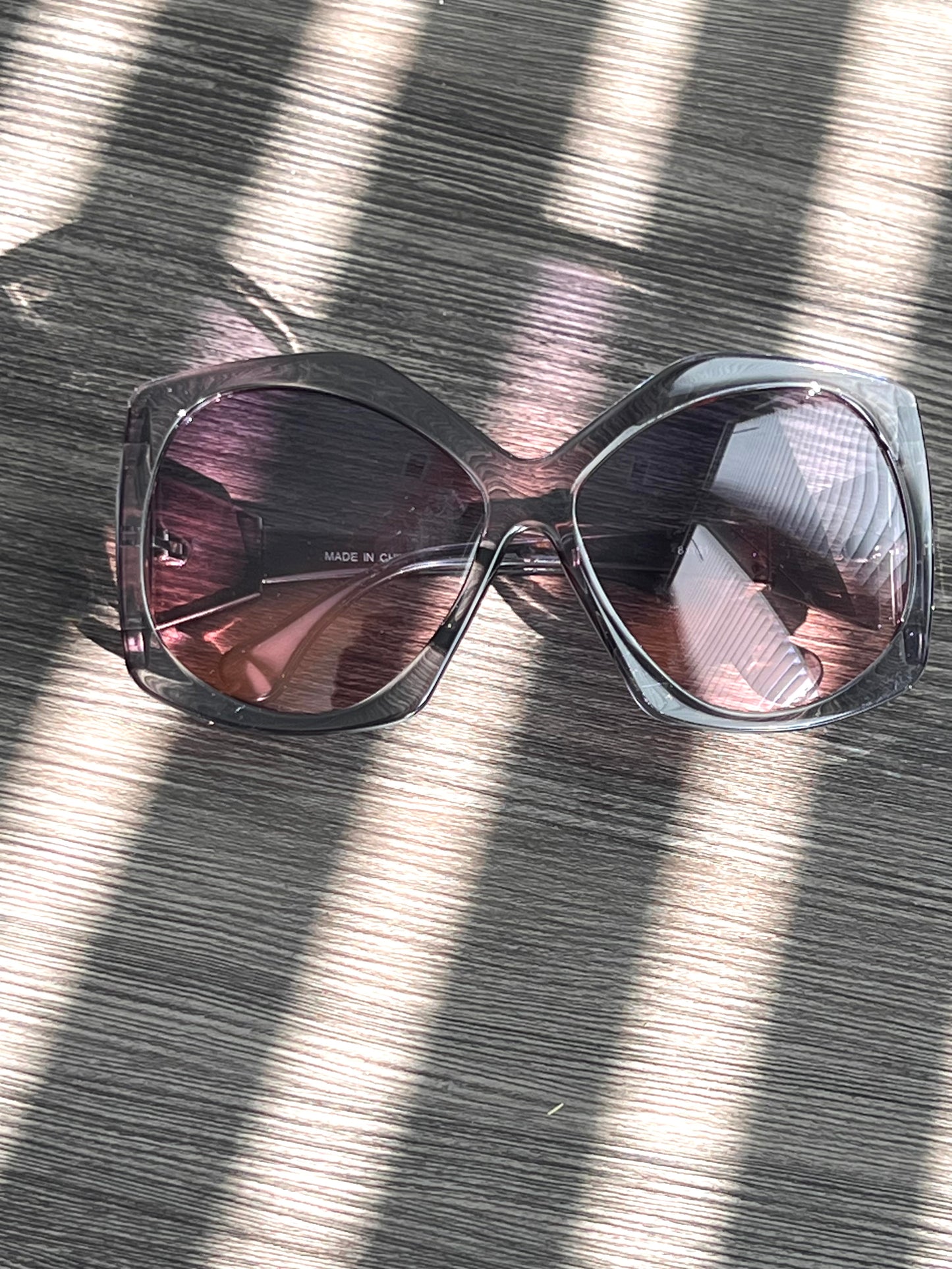 Transparent gray oversized sunglasses with soft lilac gradient lenses, sleek and modern unisex frame.