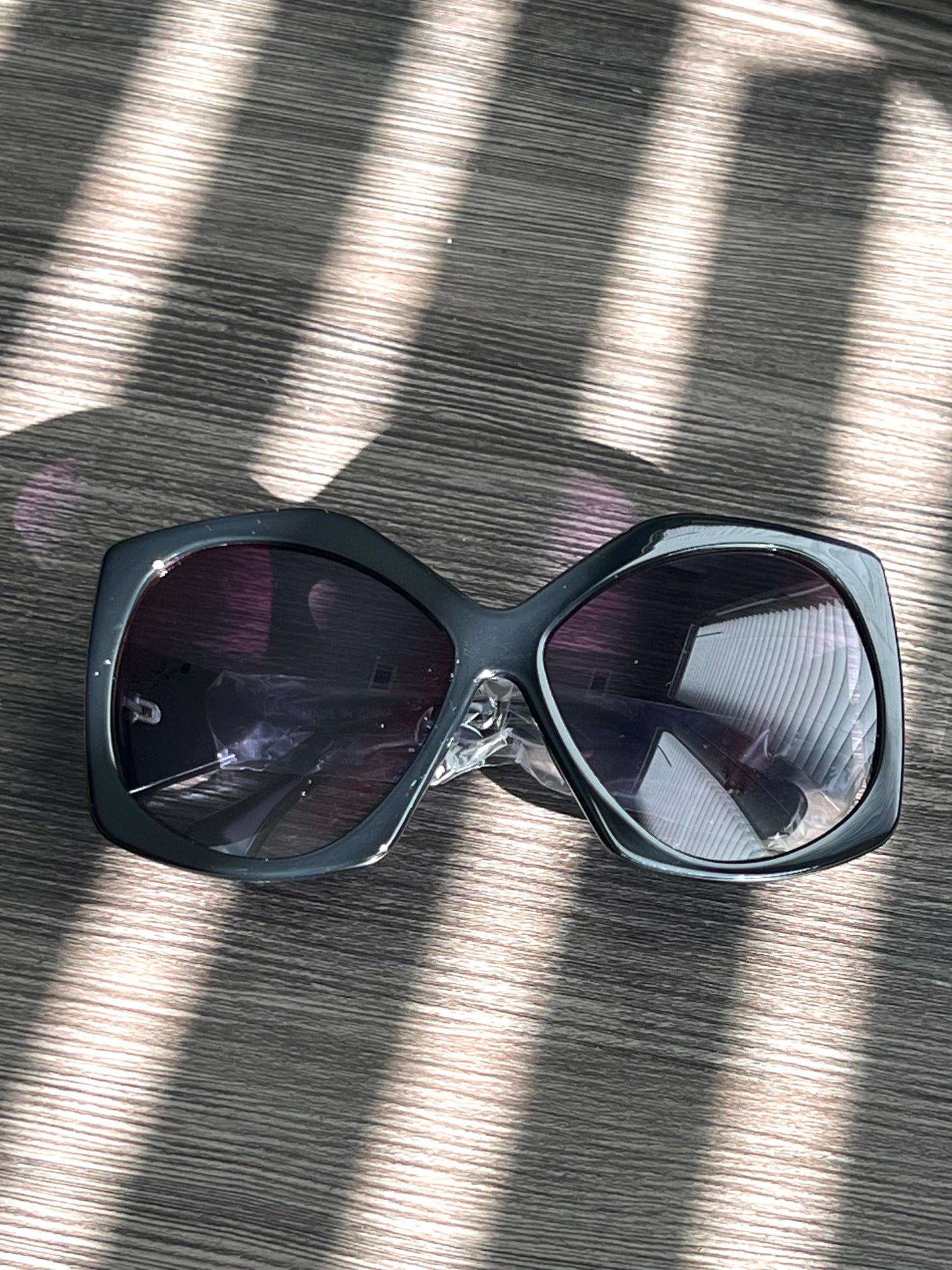 Matte black oversized square sunglasses with dark lenses, bold statement eyewear for everyday wear