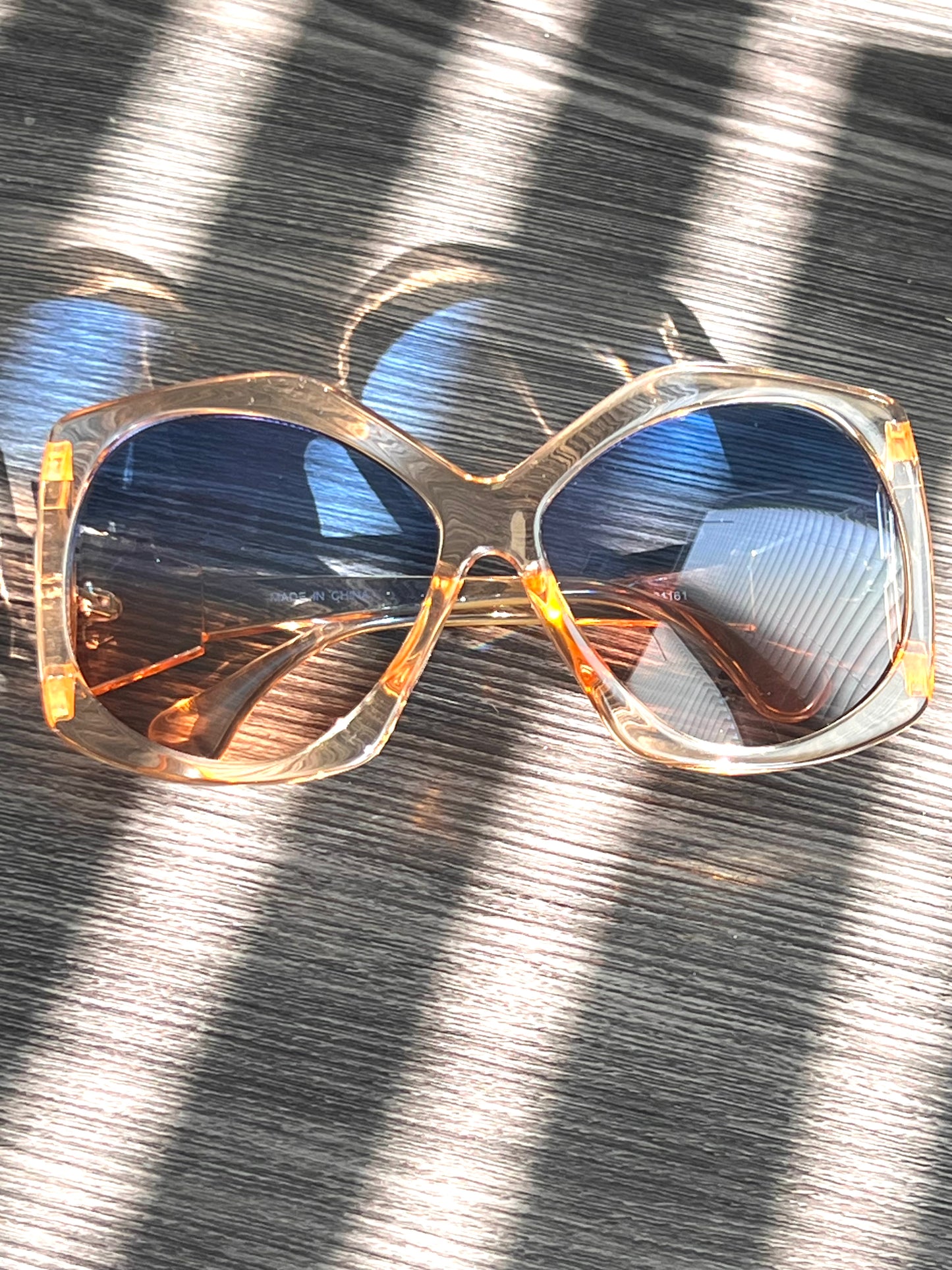Peachy nude oversized sunglasses with gradient brown lenses, neutral-toned and flattering for all skin tones