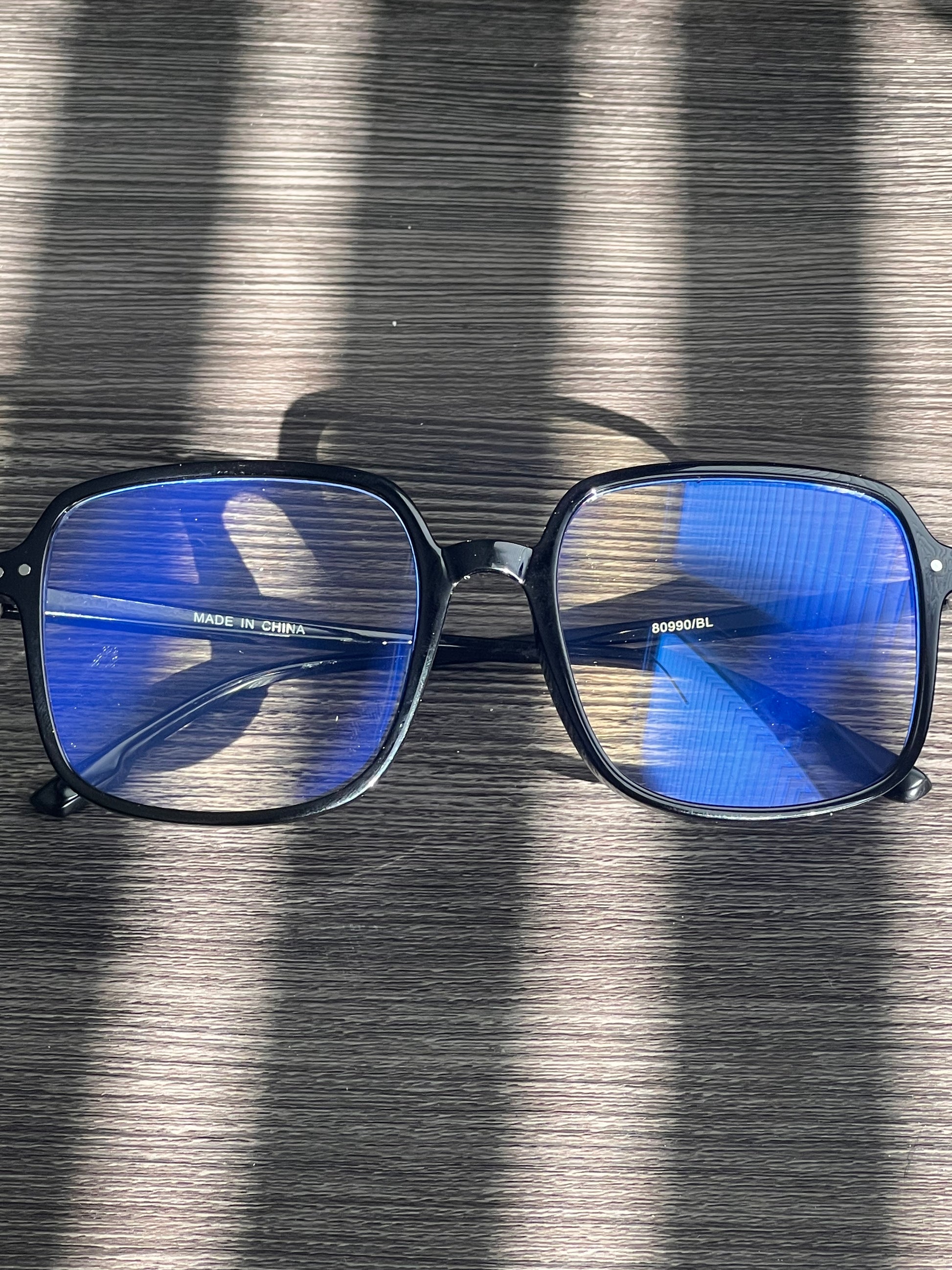 Classic black blue light glasses with bold square frames and clear protective lenses.