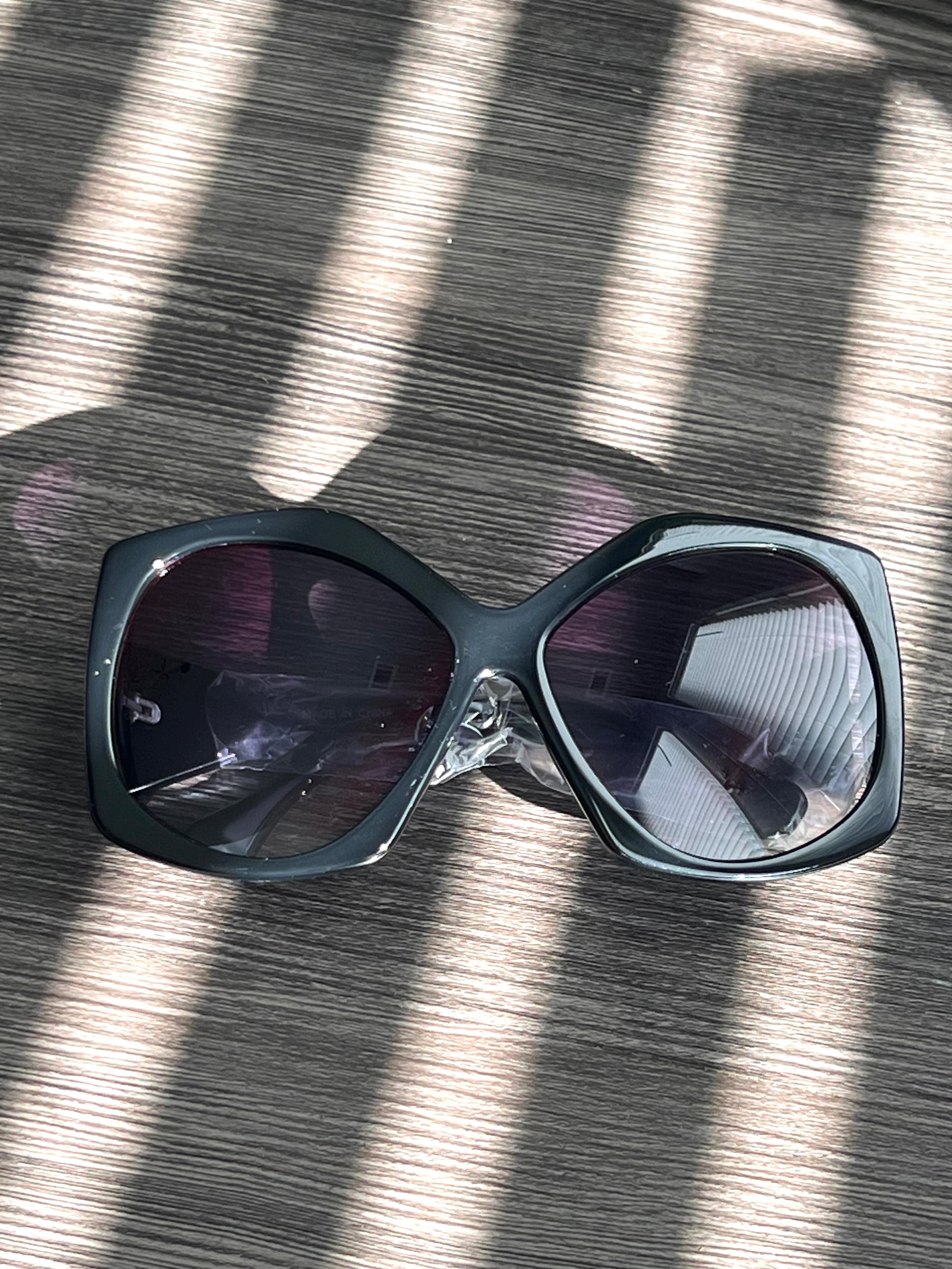 Matte black oversized square sunglasses with dark lenses, bold statement eyewear for everyday wear